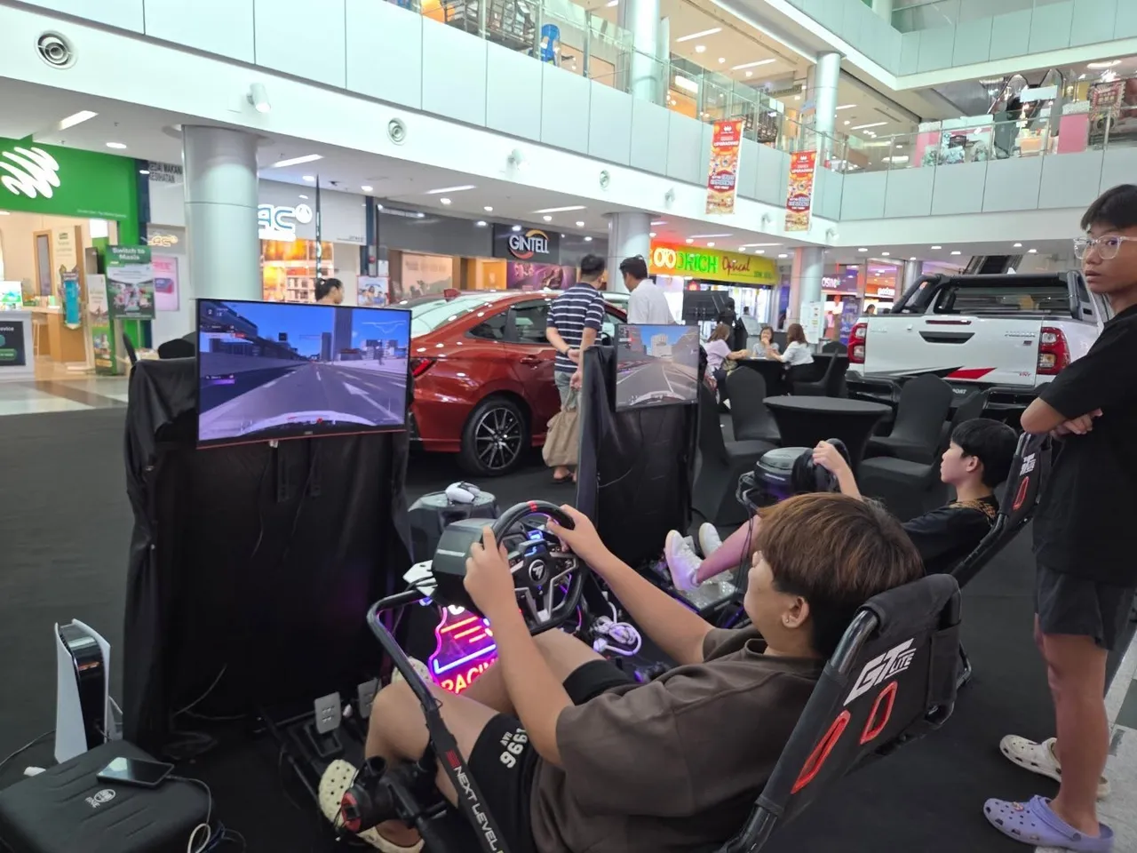 Mall crowd around the sim racing rigs at an AKG Esports activation
