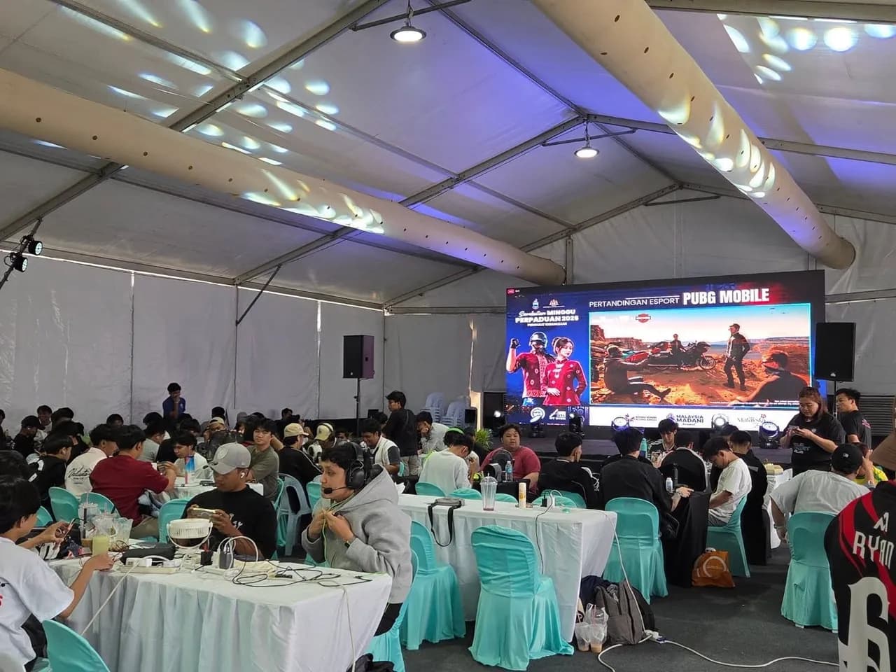 Packed crowd watching the tournament screen at an AKG Esports event